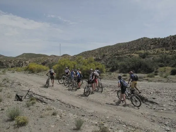 Spainventure Adventure practicing MTB Biking on El Chorro area Malaga crossing a dry river